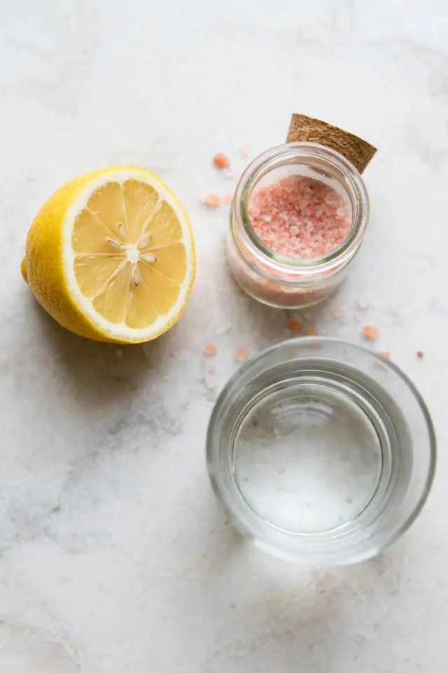 Ingredients for himalayan salt and lemon water including lemon and pink salt