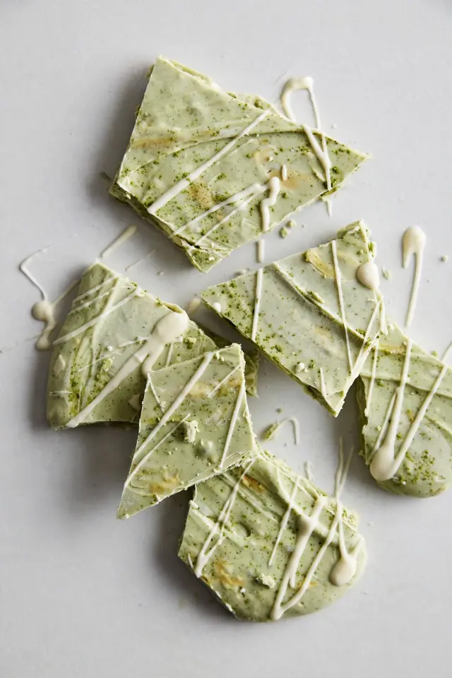 Matcha white chocolate frozen yogurt bark on gray background